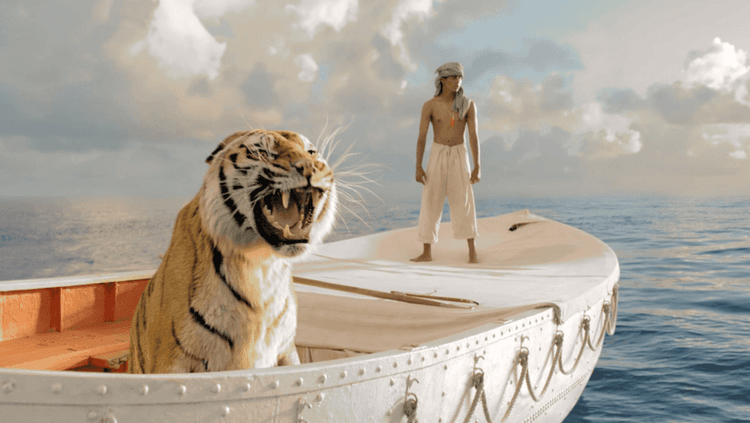 Scene from Life of Pi where the protagonist is in a boat in the ocean with a Bengal tiger